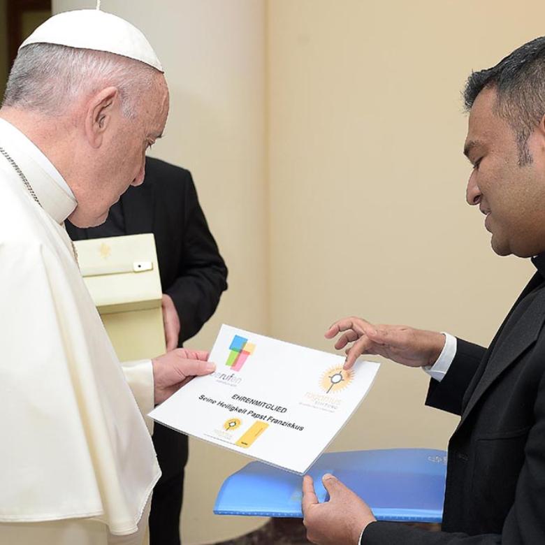 Der Direktor der Diözesanstelle für Berufungspastoral des Erzbistums Köln, Pfarrer Regamy Thillainathan, spricht mit Papst Franziskus über die rogamus-Stiftung.