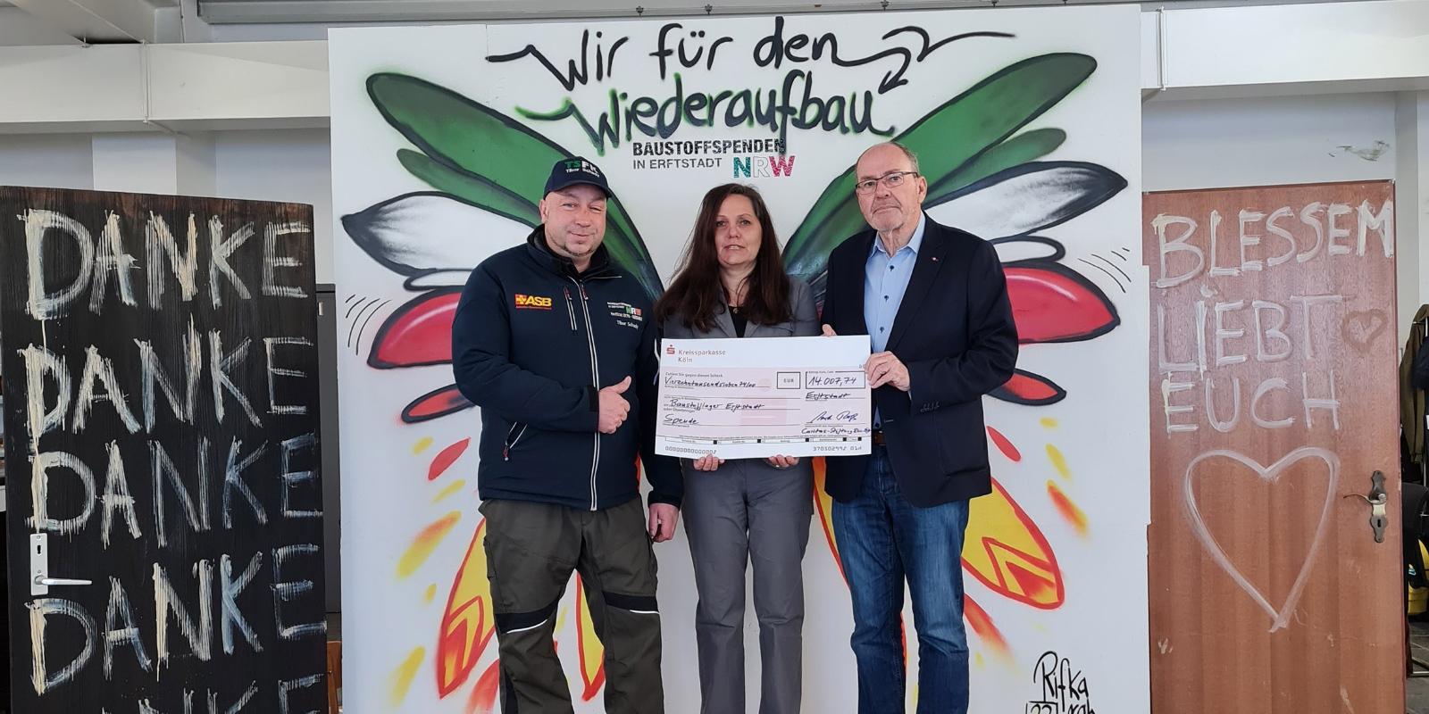 Überreichten Tibor Schady (li.), Geschäftsführer des Baustofflagers Erftstadt, symbolisch einen Scheck über 14.000 Euro: Gerd Roß (Kuratoriumsvorsitzender) und Barbara Albers (Stiftungsreferentin) von der Caritas-Stiftung Rhein-Erft.