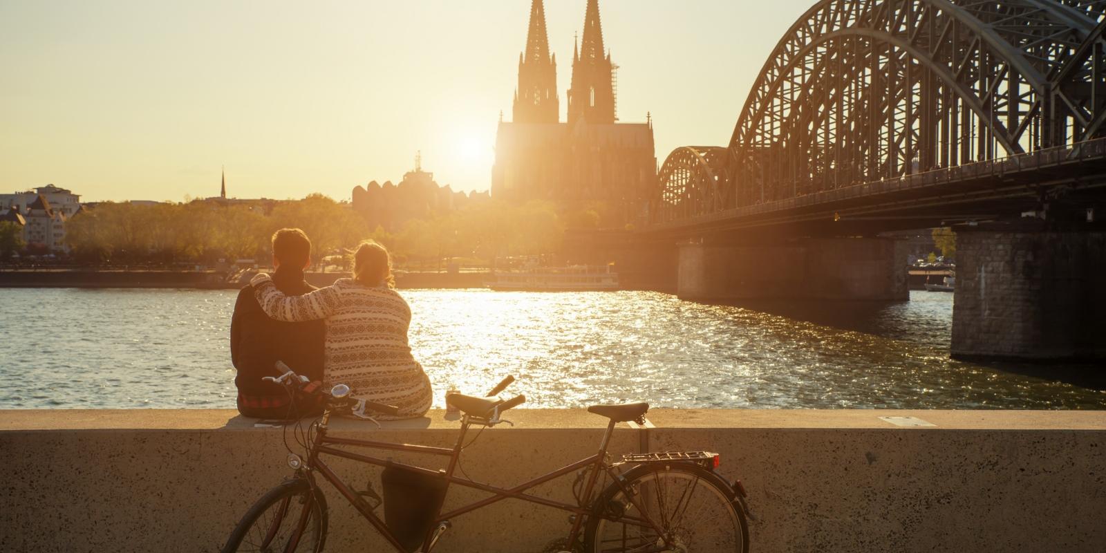Sonnenuntergang hinter dem Kölner Dom Young romantic couple spending their vacation in Cologne, Germany.